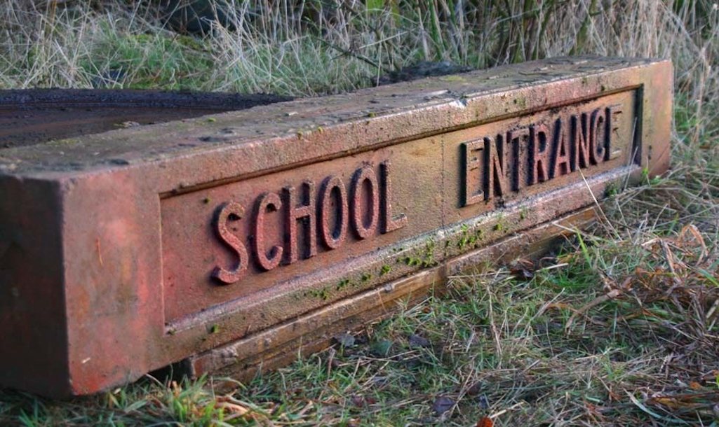 Lintel stone that used to be at the St.Matthew's, Thatto Heath, school entrance now in Sutton Manor Woodland